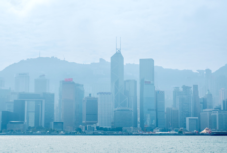 HONG KONG, CHINA - JANUARY 20 : Landmark skyscraper buildings at Victoria harbor with daylight mist, Hong Kong, China, on January 20, 2018.のeditorial素材