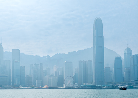 HONG KONG, CHINA - JANUARY 20 : Landmark skyscraper buildings at Victoria harbor with daylight mist, Hong Kong, China, on January 20, 2018.のeditorial素材
