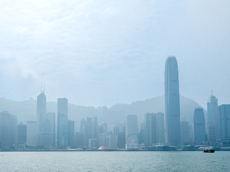 HONG KONG, CHINA - JANUARY 20 : Landmark skyscraper buildings at Victoria harbor with daylight mist, Hong Kong, China, on January 20, 2018.のeditorial素材