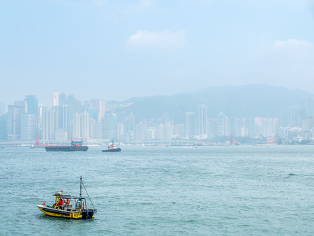 HONG KONG, CHINA - JANUARY 20 : Landmark skyscraper buildings at Victoria harbor with daylight mist, Hong Kong, China, on January 20, 2018.のeditorial素材