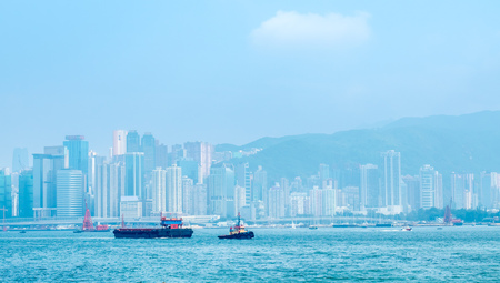 HONG KONG, CHINA - JANUARY 20 : Landmark skyscraper buildings at Victoria harbor with daylight mist, Hong Kong, China, on January 20, 2018.のeditorial素材