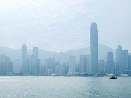 HONG KONG, CHINA - JANUARY 20 : Landmark skyscraper buildings at Victoria harbor with daylight mist, Hong Kong, China, on January 20, 2018.のeditorial素材