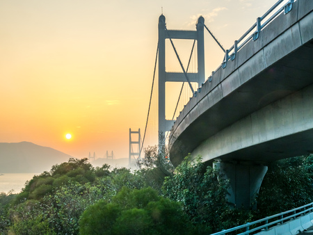 HONG KONG, CHINA - JANUARY 21 : Express way bridge cross strait with large avenue in Hong Kong, China, under sunset sky, on January 21, 2018.のeditorial素材