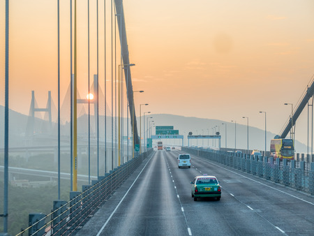 HONG KONG, CHINA - JANUARY 21 : Express way bridge cross strait with large avenue in Hong Kong, China, under sunset sky, on January 21, 2018.のeditorial素材