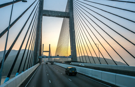 HONG KONG, CHINA - JANUARY 21 : Express way bridge cross strait with large avenue in Hong Kong, China, under sunset sky, on January 21, 2018.のeditorial素材
