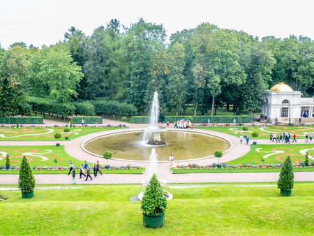PETERHOF, RUSSIA - SEPTEMBER 1 : Fountains in famous garden around Grand cascade palace of Peterhof in summer season under cloudy sky in Russia, on September 1, 2018.のeditorial素材