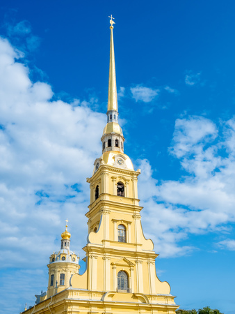 Saint Peter and Paul cathedral, the tallest bell tower in Orthodox church, located in St.Peter&Paul fortress in Saint Petersburg, Russia, under cloudy blue skyの写真素材