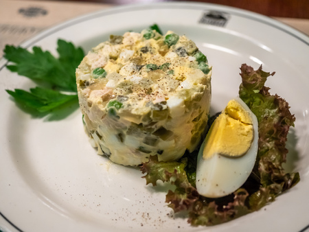 Egg salad serve on white dish in Russian restaurantの写真素材