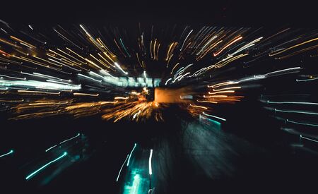 Street town unfocused motion abstract continuous lines perspectives red orange lights. Inside fast moving light sources , image used as a copy space blur background.の写真素材
