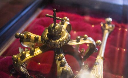 low key image of beautiful queen/king Luxury crown golden jewelry on  red satin . vintage filtered....