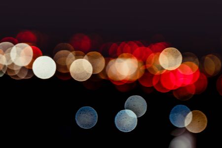 Blur bokeh , red round circles of a evening night city. Motion unfocused image , copyspace photo,...