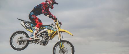MX moto cross racing - Bike Rider riding on dirt track - extreme jump. Extreme Motocross.vの写真素材