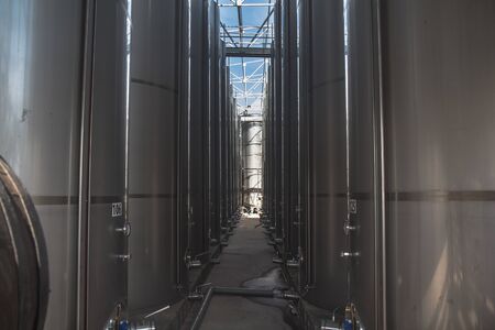 Modern Â storage technology agro-industry, metal containers for grain business  granary trail perspective . Grain-drying Complex, Commercial  Seed Silos in Summer , sunny day, blue sky, white clouds .の写真素材