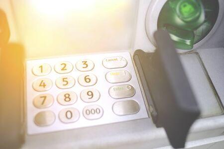 Close-up entering PIN numbers buttons ATM on bank machine . Concept of insecure strangers ,  online...