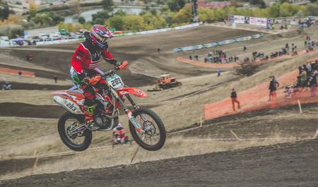 MX moto cross racing - Girl Bike Rider riding on dirt track - extreme jump. Extreme Motocross.の写真素材