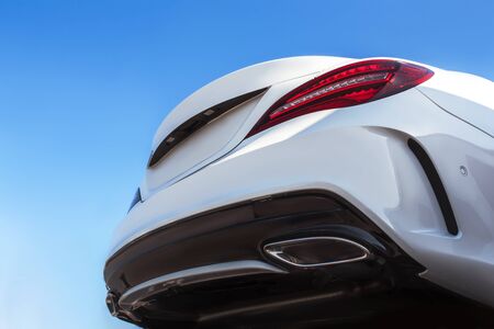 Car detailing : Glass coating Closeup modern glossy shine View below modern luxury Back bumper, lights sport car headlight head lamp. Car dealership office showroom wallpaper. Design Automobile rentalの写真素材