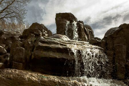 Spraying stream waterfall  Splashing mountain water in motion. Tropical rocks and stones. Water...