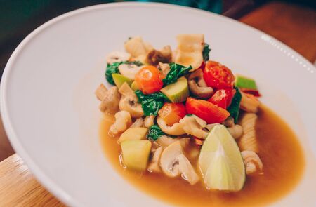 Waiter serving warm Salad asparagus  squid shrimp at restaurant, close up view. Eating and leisure concept. Toned image. Design healthy lifestyle Organic Gourmet and luxury concept serviceの写真素材