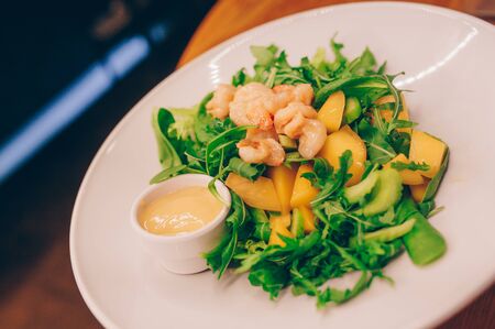 Waiter serving Salad rucola asparagus salad Caesar at restaurant, close up view. Eating and leisure concept. Toned image. Design healthy lifestyle Organic Gourmet and luxury concept service

の写真素材