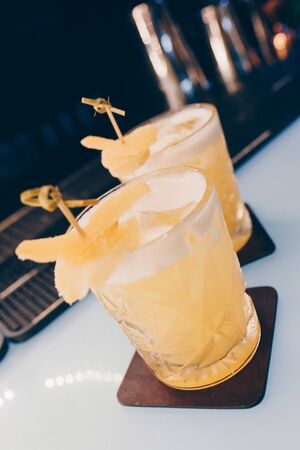 Sweet Famous white with caramels decoration slice  Author inspired Cocktail Drink - on bar counter . Close-up Top view . Copy paste space for design people and luxury service barman in nightclubの写真素材