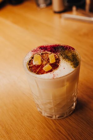 Sweet Famous white with caramels decoration slice  Author inspired Cocktail Drink - on bar counter . Close-up Top view . Copy paste space for design people and luxury service barman in nightclubの写真素材