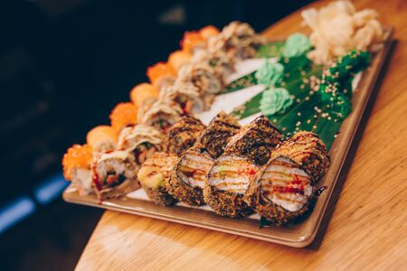 Large set of Sushi Rolls Warm Ebi Sake Unagi Spring. A lot assortment Philadelphia roll Dishes from Japanese raw fish  in one plate in traditional restaurant. Japan food menu serviceの写真素材