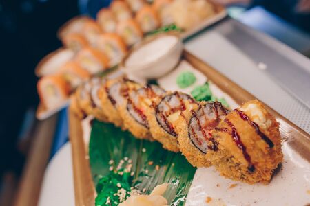 Large set of Sushi Rolls Warm Ebi Sake Unagi Spring. A lot assortment Philadelphia roll Dishes from Japanese raw fish  in one plate in traditional restaurant. Japan food menu serviceの写真素材