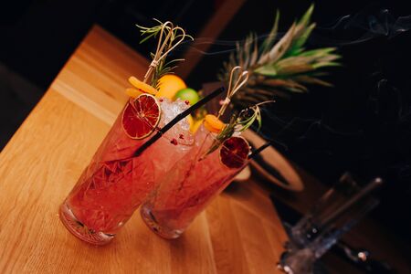 Fresh summer  Author inspired Cocktail Drink - on bar counter on Pineapple fruits Background  . Close-up Top view . Copy paste space for design people and luxury service barman in nightclubの写真素材