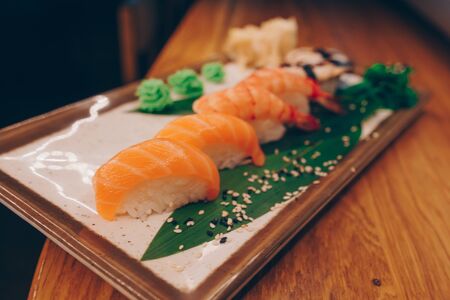 Large set of Sushi Rolls Warm Ebi Sake Unagi Spring. A lot assortment Philadelphia roll Dishes from Japanese raw fish  in one plate in traditional restaurant. Japan food menu serviceの写真素材