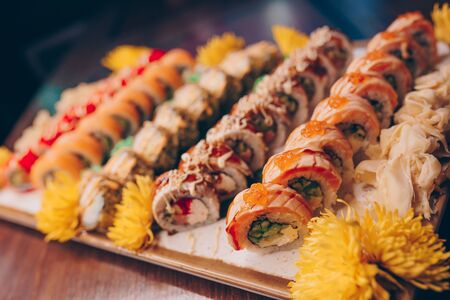 Large set of Sushi Rolls Warm Ebi Sake Unagi Spring. A lot assortment Philadelphia roll Dishes from Japanese raw fish  in one plate in traditional restaurant. Japan food menu serviceの写真素材