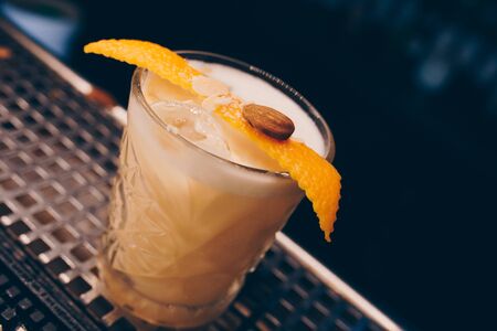 ice cold modern Cocktail  gourmet craft white with Sweet caramels decoration slice Author Drink - on...