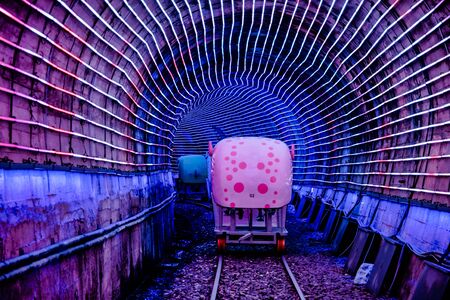 Four-wheeled bicycles on abandoned train tracks, inside the light tunnel. It's a popular place to relax, in Badouzi, Keelung, Taiwan. August 21, 2019のeditorial素材