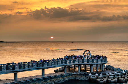 Beautiful sunset on the coast,Zhilan Park Ocean Viewing Platform in Sanzhi, New Taipei City, Taiwanの写真素材