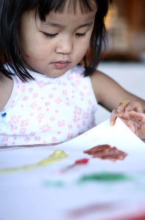 child painting and playing with colours (chinese child)の写真素材