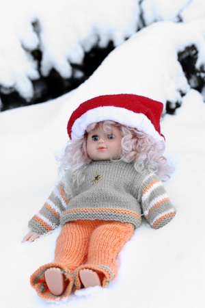 close up picture of a christmas doll  in the snowの写真素材