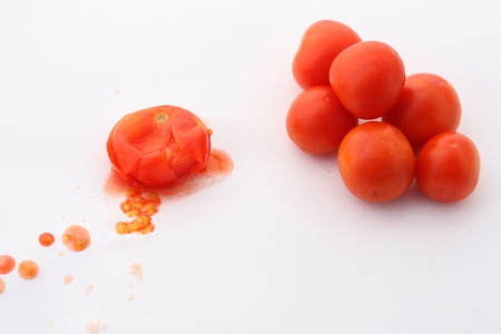 squashed tomato close up / white background の写真素材