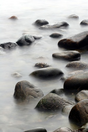 stones in the water in denmark on the north coast of the seeland islandの写真素材