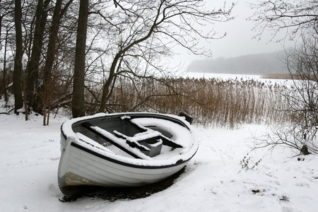 boat on iced  lake in denmark in winterの写真素材