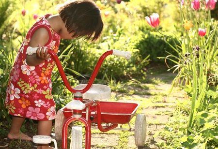 child playing bare feet in spring in a gardenの写真素材