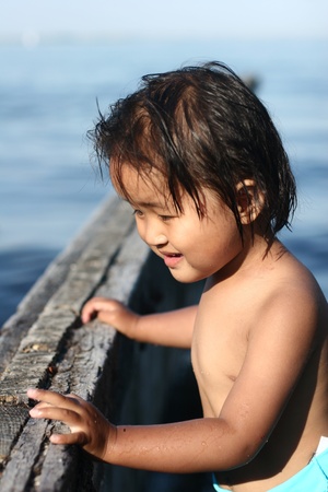 child  having fun with water  a summer day at the beachの写真素材