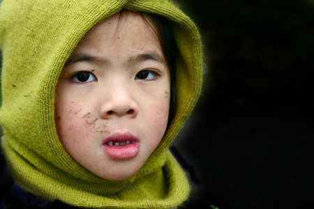 chinese child pensive attitude with winter hatの写真素材