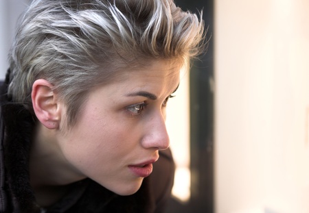 woman outdoor in a city on shopping tour, looking into a shop windowの写真素材