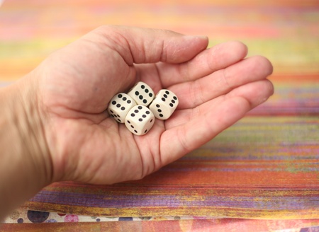 playing with several white dices on various backgroundsの写真素材