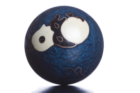 A single ball placed on a reflective surfaceの写真素材