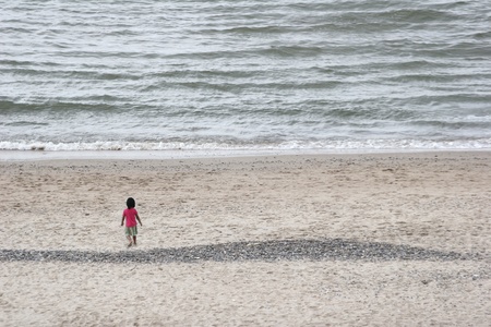 Child playing  a summer day at the beach in denmarkの写真素材