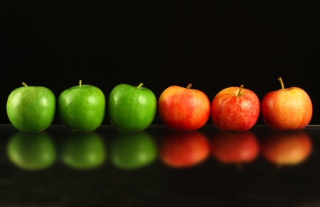 Apples in a row on black backroundの写真素材