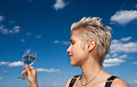 Cute blond girl playing with water in the summer in Denmarkの写真素材