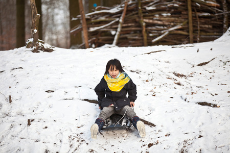 Girl sledging in winter in Denmarkの写真素材