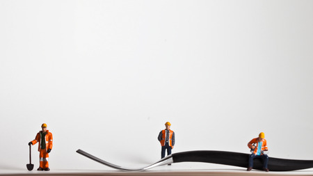 Miniature people in action in various situationsの写真素材