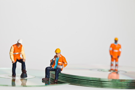 Miniature people in action in various situationsの写真素材